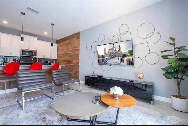 tiled living room featuring wooden walls