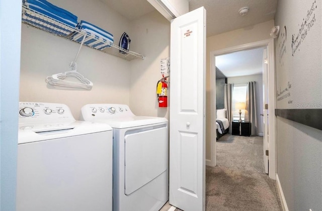 laundry room with light carpet and washer and dryer