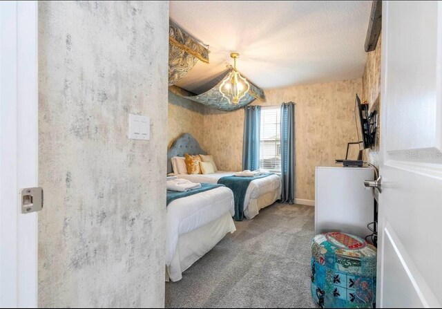 carpeted bedroom featuring a textured ceiling