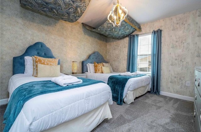 carpeted bedroom with a notable chandelier