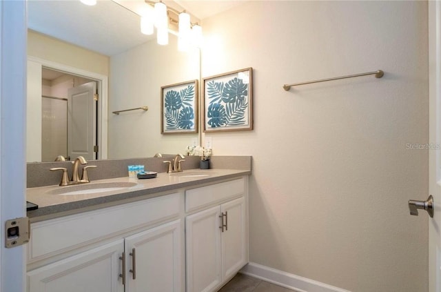 bathroom with tile patterned flooring, vanity, and a shower with door