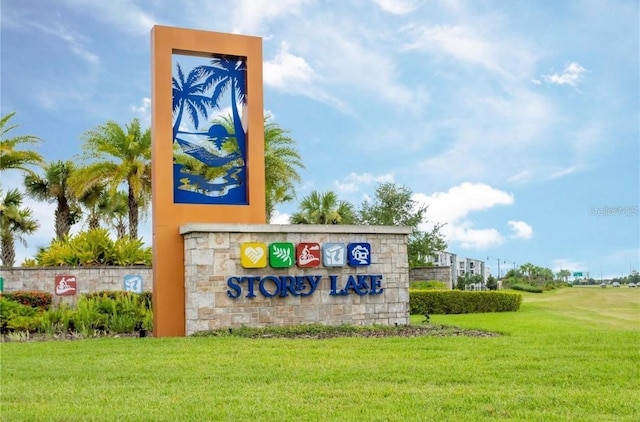 community / neighborhood sign with a lawn