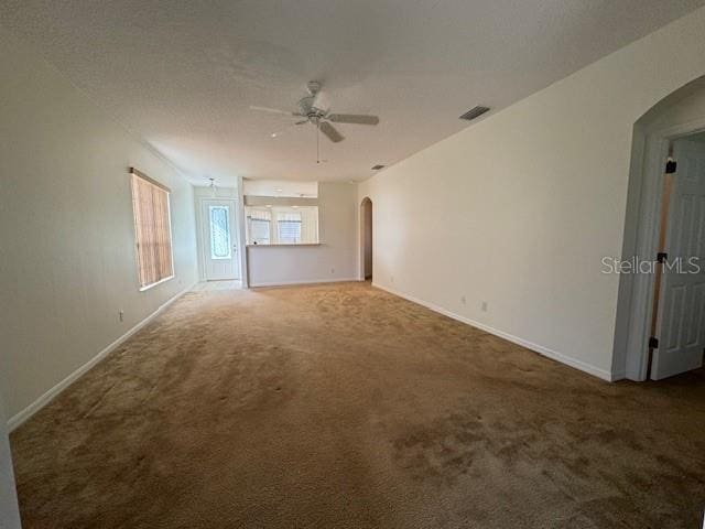 carpeted spare room featuring ceiling fan