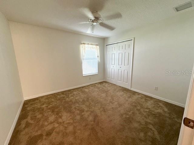 empty room featuring carpet floors and ceiling fan