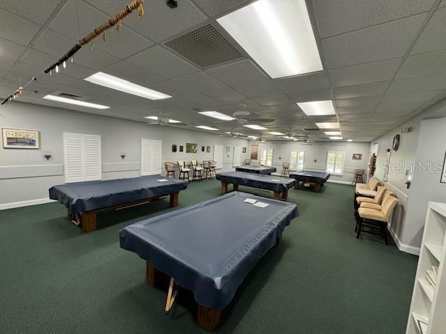 playroom with billiards, dark carpet, and a drop ceiling