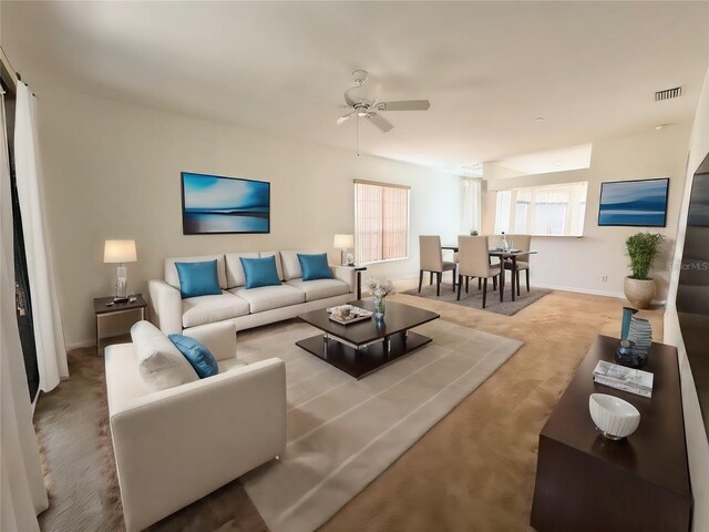 carpeted living room featuring ceiling fan