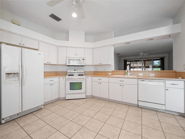 kitchen featuring light countertops, white appliances, a sink, and visible vents