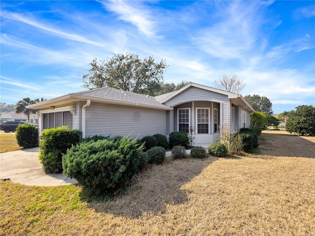 view of side of home with a yard and an attached garage