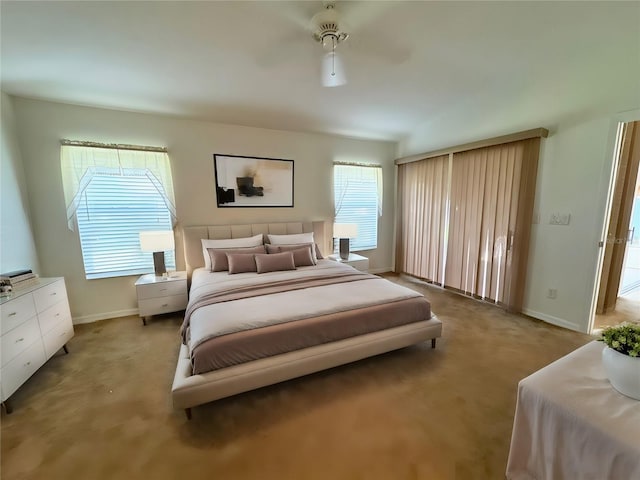 bedroom featuring light carpet, ceiling fan, and baseboards