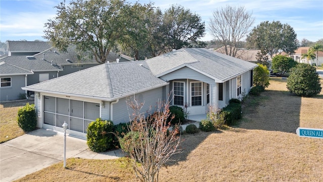 single story home with a garage, driveway, a shingled roof, and a front lawn