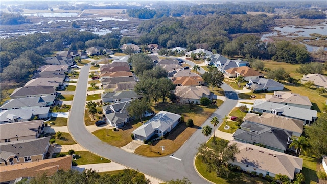 drone / aerial view featuring a residential view and a water view