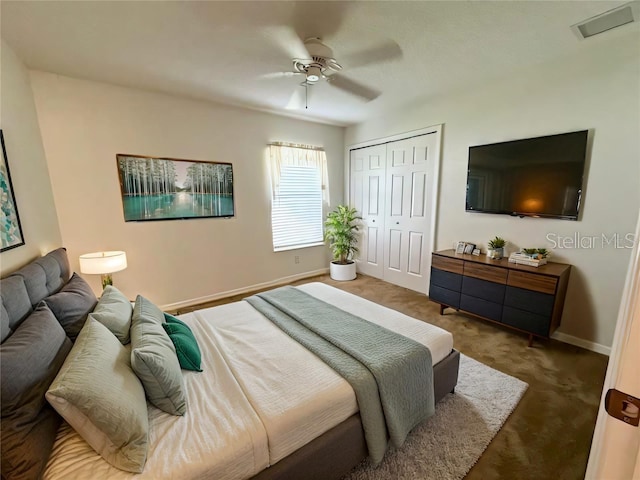 bedroom with a closet, carpet flooring, a ceiling fan, and baseboards