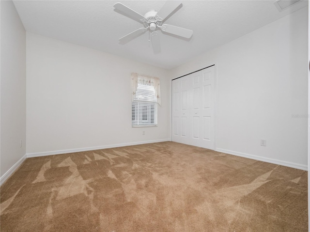 unfurnished bedroom with a closet, carpet flooring, visible vents, and baseboards