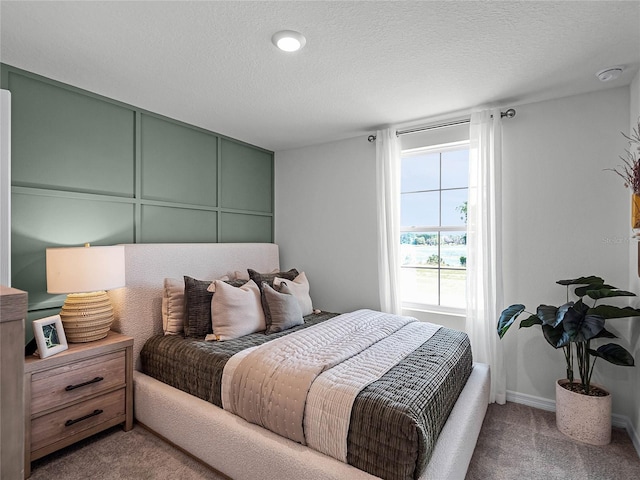 carpeted bedroom with a textured ceiling