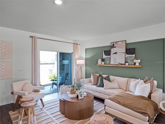 living room with a textured ceiling and hardwood / wood-style floors