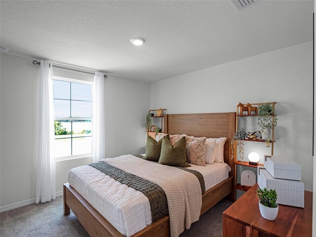 bedroom featuring carpet floors and a textured ceiling