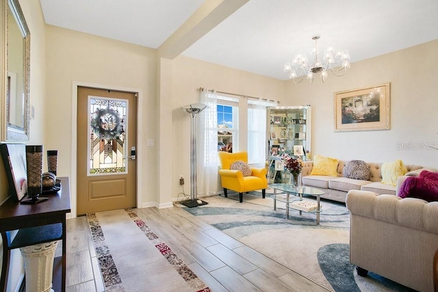 living room featuring a notable chandelier and light wood-type flooring