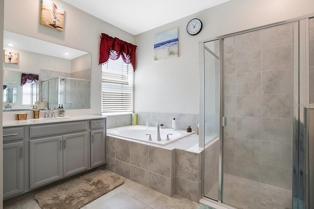 bathroom with tile patterned flooring, vanity, and separate shower and tub