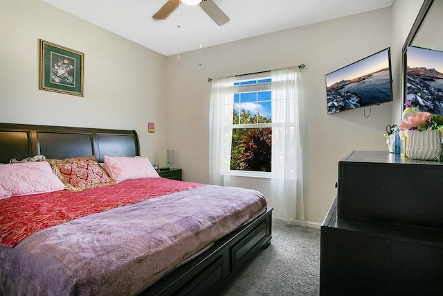 bedroom featuring ceiling fan and dark carpet