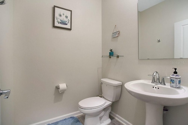 bathroom featuring sink and toilet