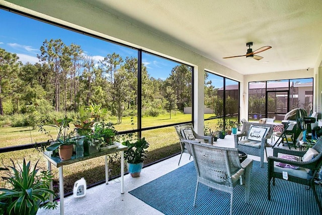 sunroom featuring ceiling fan