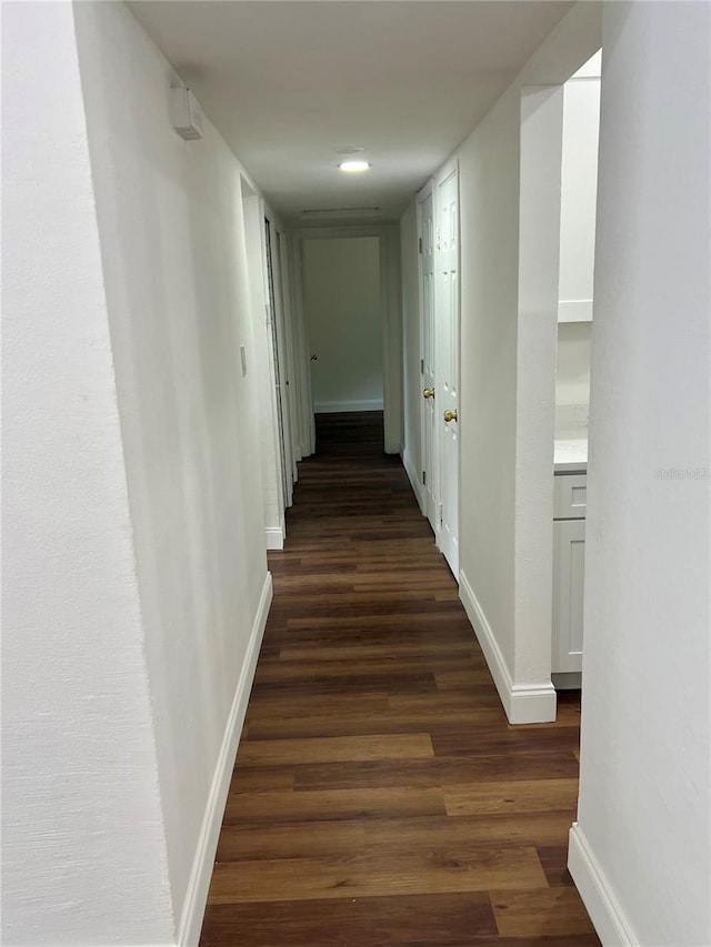 corridor with dark hardwood / wood-style floors