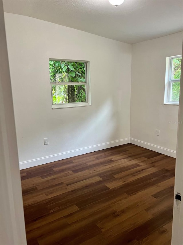 empty room featuring dark hardwood / wood-style flooring