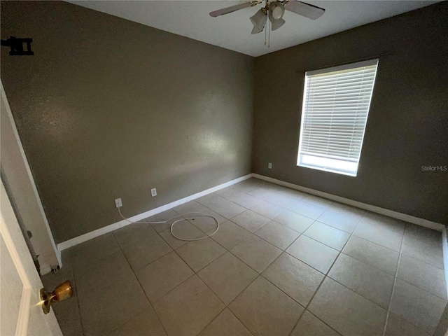 unfurnished room with tile patterned floors and ceiling fan