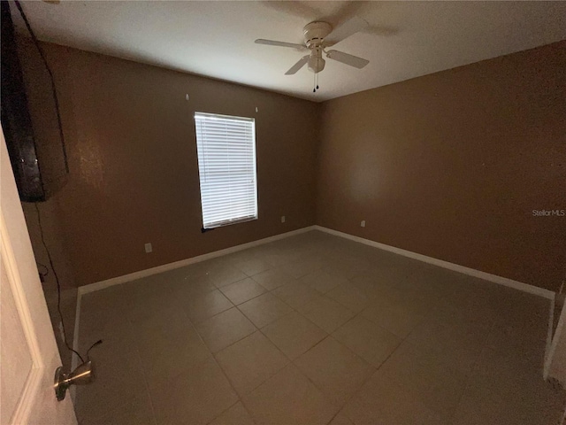 tiled empty room with ceiling fan