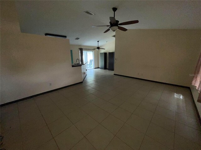 tiled empty room featuring sink and ceiling fan