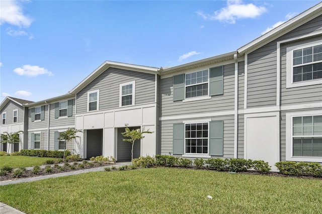 view of property featuring a front lawn