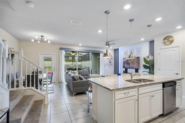 kitchen featuring dishwasher, white cabinetry, sink, light stone countertops, and ceiling fan with notable chandelier