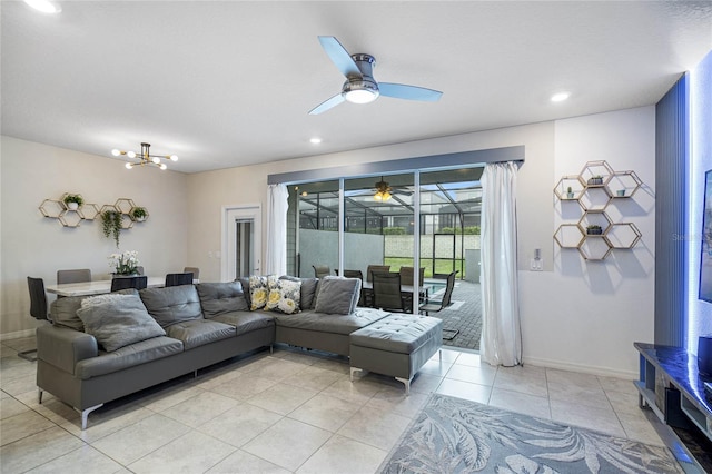 living room with ceiling fan with notable chandelier and light tile patterned flooring