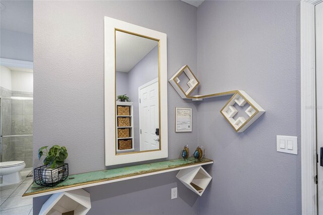 details with tile patterned flooring and toilet