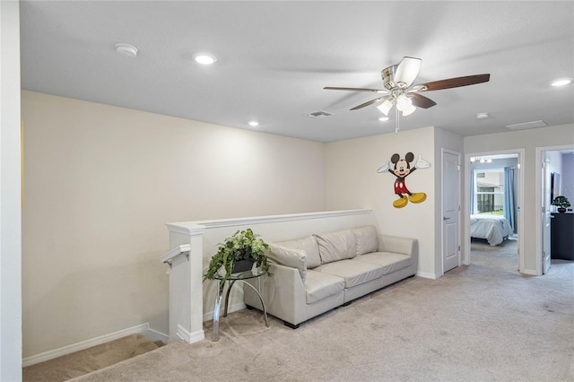 carpeted living room with ceiling fan