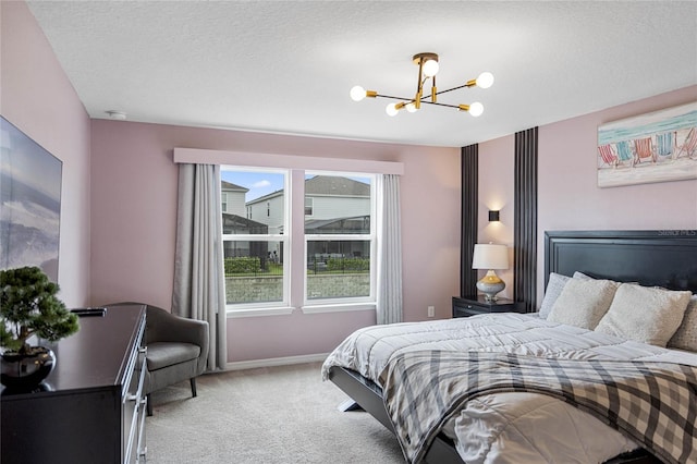 carpeted bedroom with an inviting chandelier, a textured ceiling, and multiple windows