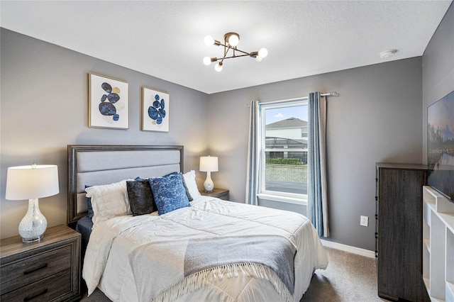 bedroom with an inviting chandelier and carpet floors