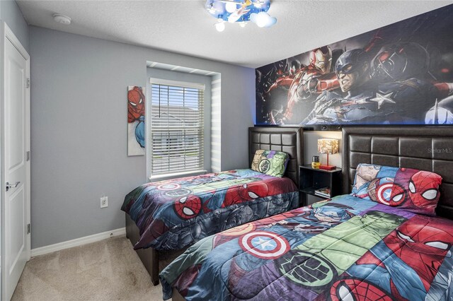 carpeted bedroom featuring a textured ceiling