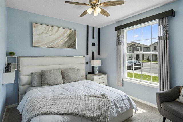 bedroom with ceiling fan and carpet