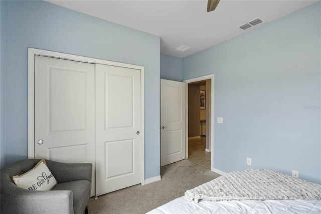 carpeted bedroom featuring ceiling fan and a closet