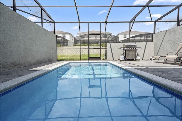 view of swimming pool featuring a lanai