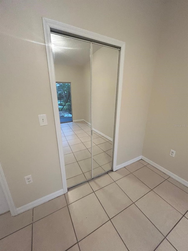 hall featuring light tile patterned floors