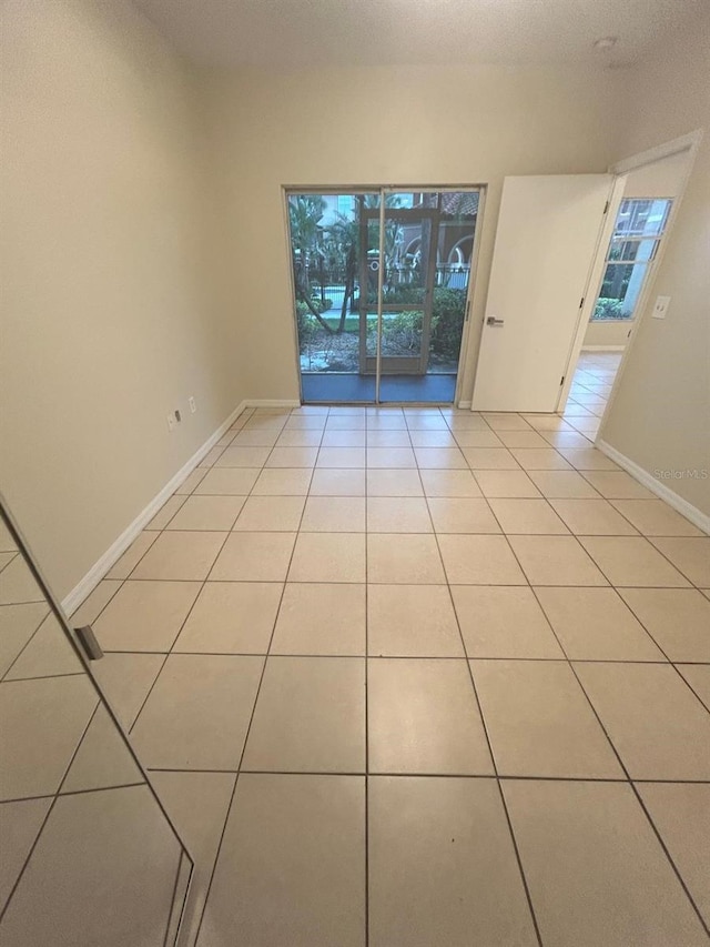 5578 Metrowest Blvd Unit 107, Orlando, FL 32811 - unfurnished room featuring plenty of natural light, light tile patterned floors, and baseboards