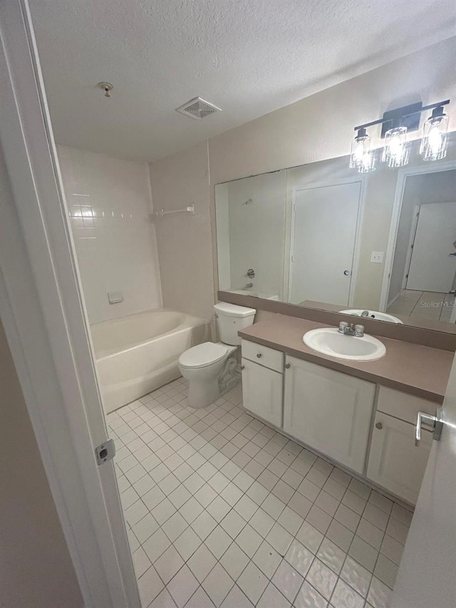 full bathroom featuring tile patterned flooring, vanity, shower / bathing tub combination, a textured ceiling, and toilet