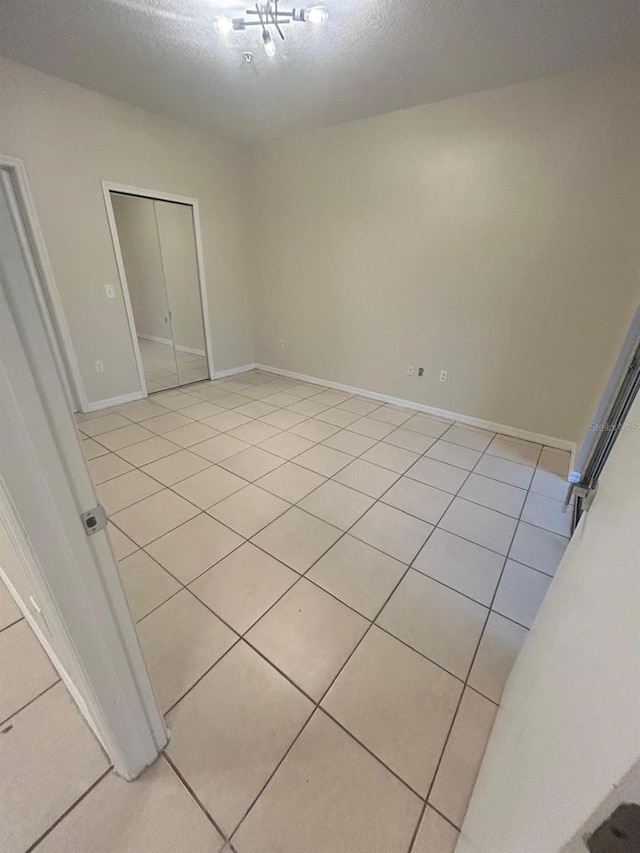 unfurnished bedroom featuring a textured ceiling and a closet