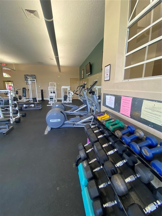 5578 Metrowest Blvd Unit 107, Orlando, FL 32811 - exercise room with a textured ceiling