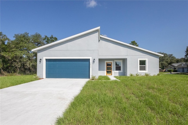 view of front of home with a front yard and a garage