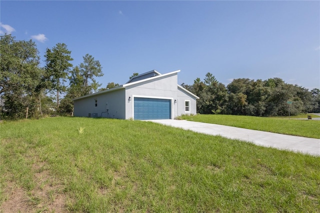 view of side of home featuring a yard and a garage