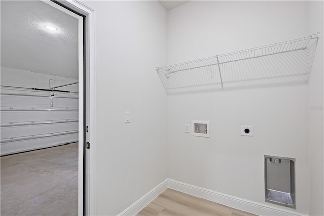 laundry area featuring electric dryer hookup, hookup for a washing machine, and hardwood / wood-style floors