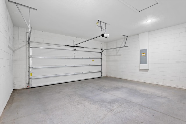 garage with a garage door opener and electric panel